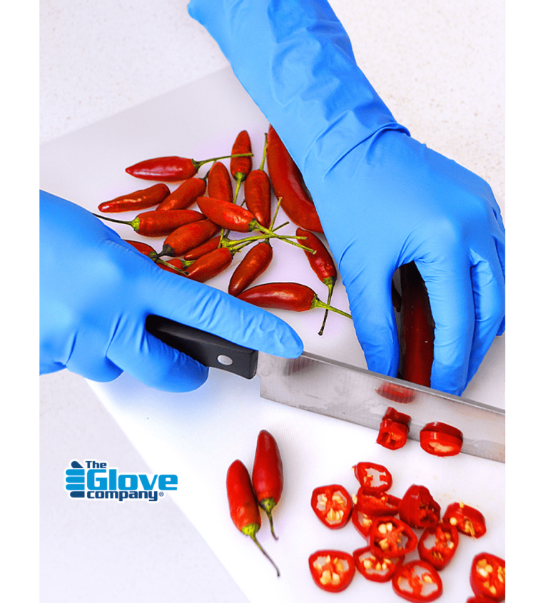 Hands wearing microlite Expert Plus cutting chilli's